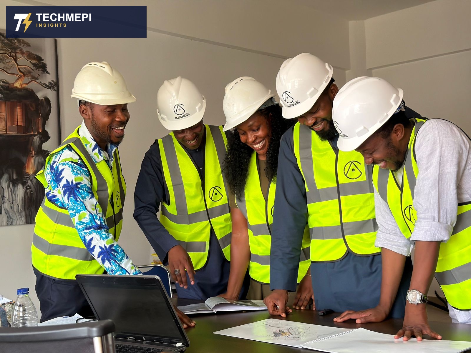 A diverse engineering team reviewing building plans together